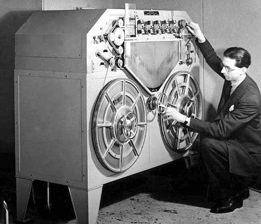 A man about to play "In E" by Water Damage on a Marconi-Stille steel tape recorder.