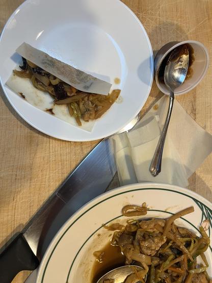 Moo Shu chicken in a bowl next to a plate with a small filled pancake