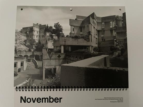 Photo of the November page of the 2025 Brutalist Calender illustrated with a photo of the Albert Einstein School and Cite du Parc, France — a multi-story angular concrete building with multiple balconies and staircases