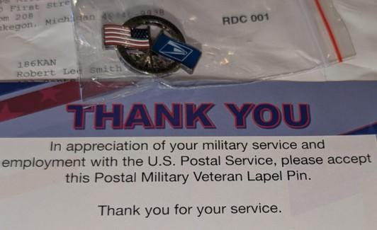note and lapel pin from usps thanking veteran for his service received while not being paid fairly.