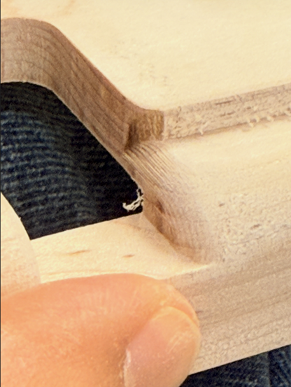 Close-up of a very rounded edge in solid wood with parallel tool marks