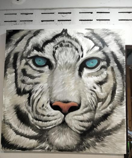 a painting of the face of a white tiger, its eyes blue, looking at the viewer 