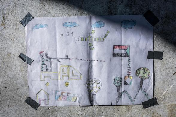 A drawing created by a young Sudanese refugee, showing a plane and a soldier shooting.
