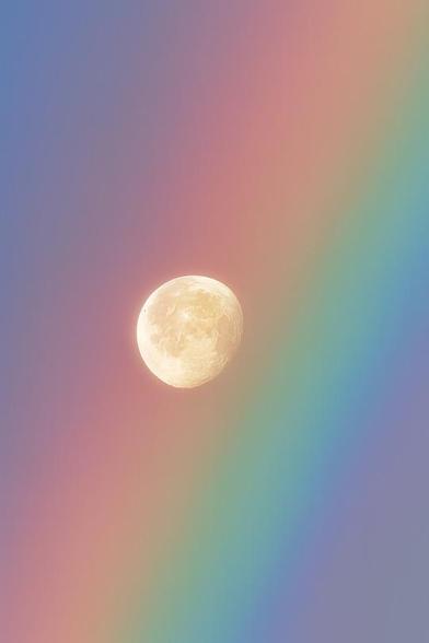 The moon perfectly framed by a rainbow even closer.