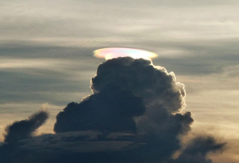 The above image was taken just before sunset when it was noticed by chance by a photographer in Murambi East, near Odzi Valley and the Mtanda Range of Zimbabwe. Also captured were unusual cloud ripples above the pileus cloud. The formation of a rare pileus cloud capping a common cumulus cloud is an indication that the lower cloud is expanding upward and might well develop into a storm. In this case, however, only a few minutes after the colorful cloud was noticed, it disappeared.