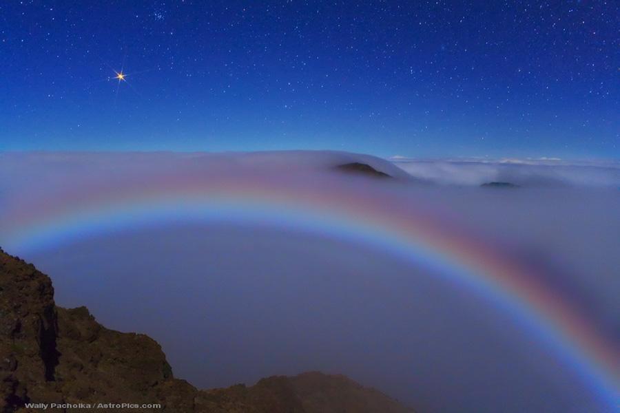 The brightness of the red planet peaked last week near when Mars reached opposition, the time when Earth and Mars are closest together in their orbits. Arching across the lower part of the image is a rare lunar fog bow. Unlike a more commonly seen rainbow, which is created by sunlight reflected prismatically by falling rain, this fog bow was created by moonlight reflected by the small water drops that compose fog. Although most fog bows appear white, all of the colors of the rainbow were somehow visible here. The above image was taken from high atop Haleakala, a huge volcano in Hawaii, USA.
Credit & Copyright: Wally Pacholka (AstroPics.com, TWAN)