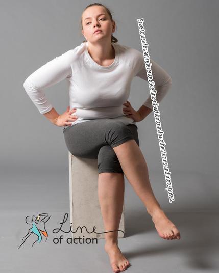 Model Olga poses in a white shirt with knee-length grey pants. The Line of Action logo is at the bottom. Text reads: Free to use for art reference. See line-of-action.com for other terms and more poses.