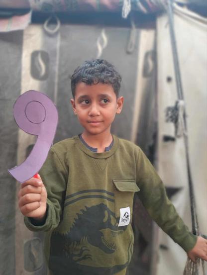 Saji is looking a little more smiling and he is holding a purple paper in the shape of number 9 because today is his birthday!