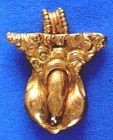 Roman gold amulet of a phallus below a pubic triangle with well-crafted pubic curls. It seems to be a flaccid phallus with a long, tapered foreskin, the beauty ideal at the time.