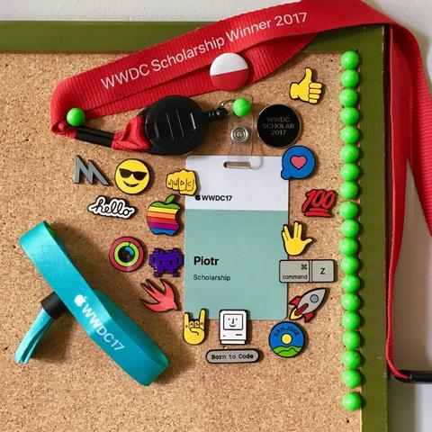 Corkboard with WWDC lanyards, a WWDC17 scholarship badge labeled "Piotr," colorful tech pins and green pushpins lining the frame.