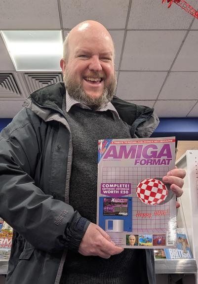 Amiga Addict editor Ian Griffiths holding the new Amiga Format branded Issue 40, in TGJones
