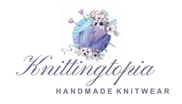 The image is a logo for "Knittingtopia Handmade Knitwear." It features an illustration of a ball of purple and blue yarn with knitting needles and adorned with flowers. The text "Knittingtopia" is written in a cursive font, while "HANDMADE KNITWEAR" is in uppercase letters below it.