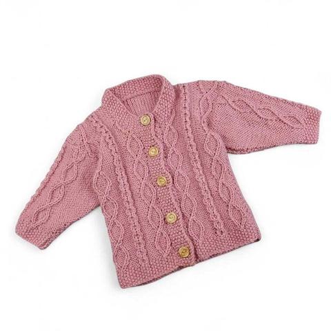 Pink hand-knitted baby cardigan with cable-knit patterns,  wooden buttons on a white background