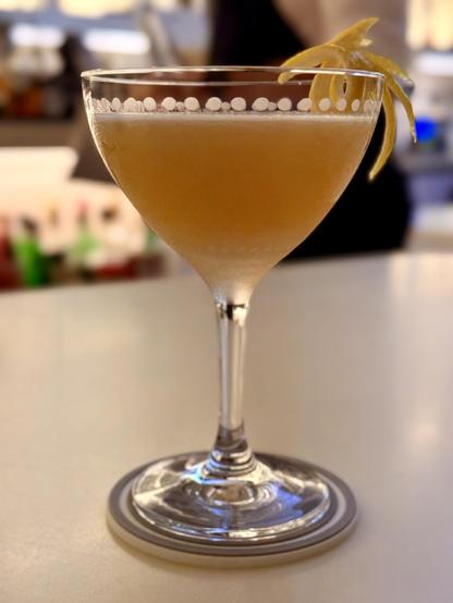 Gopalito cocktail in a pretty glass. Gin, amontillado, honey, ginger, sudachi, lemon, sesame oil