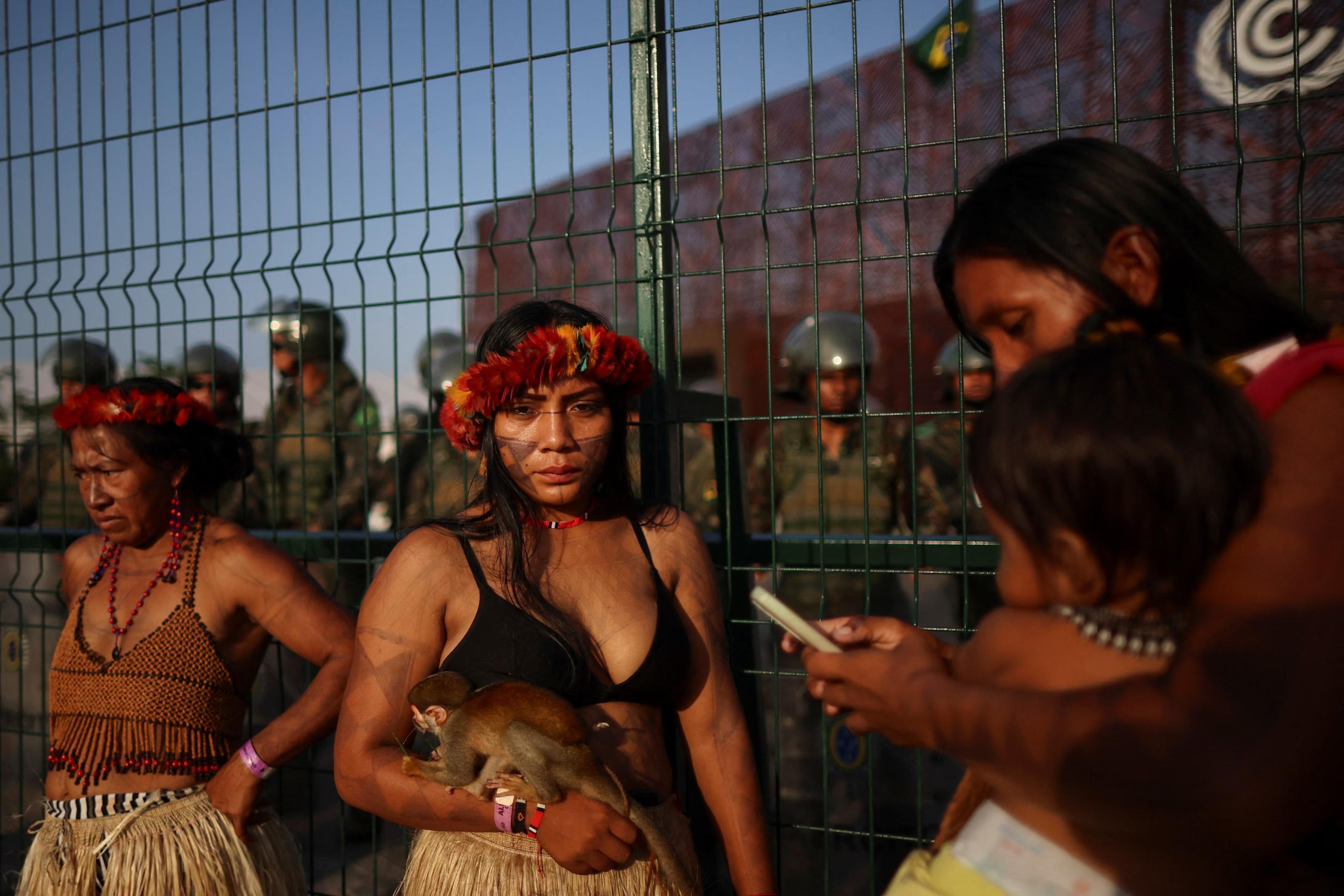 A Munduruku woman holds a squirrel monkey.