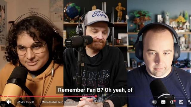 Three people wearing headphones and speaking into microphones in a split-screen video call/podcast layout, with closed captions visible at the bottom.
Caption shows "Remember Fan B? Oh yeah, of".