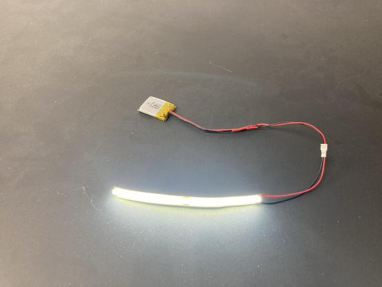 A COB LED strip connected to a battery.
