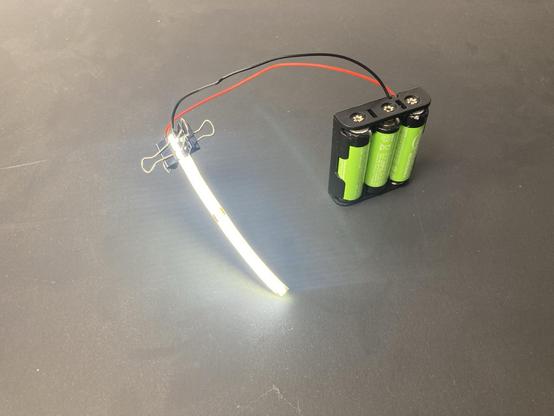 A COB LED strip connected to a battery pack.
