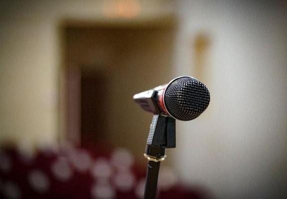 A black microphone in a meeting room.