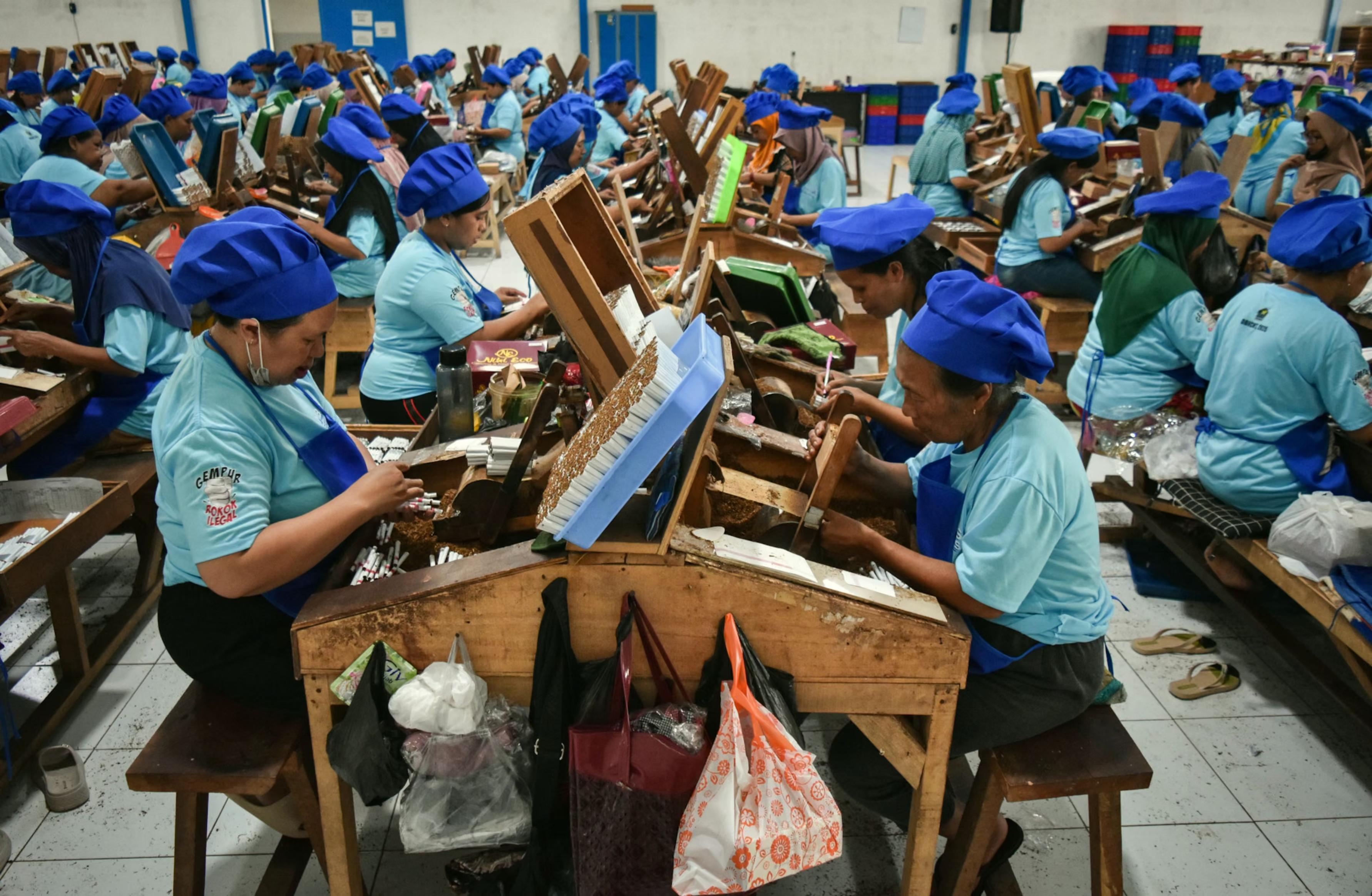 Female factory workers make hand-rolled kretek cigarettes.
