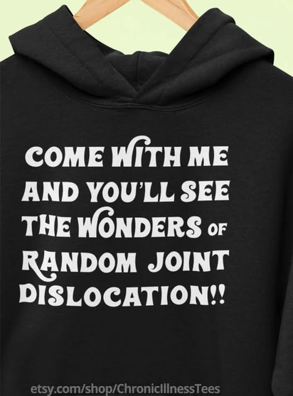 a black hoodie with white lettering - come with me and you'll see the wonders of random joint dislocation!
etsy.com/shop/ChronicIllnessTees