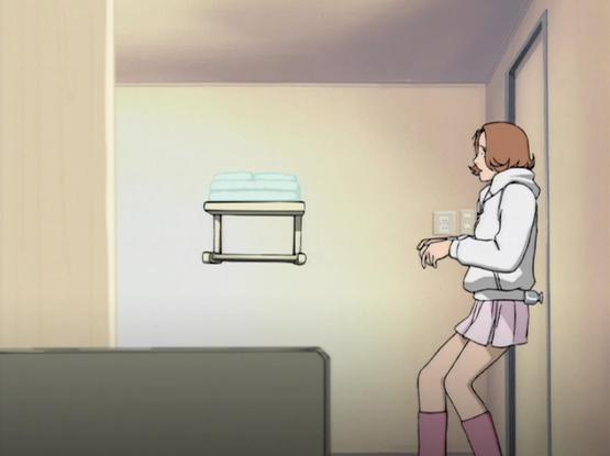 A teenage girl (Hiroko) appearing terrified seeing the reflection in the mirror.