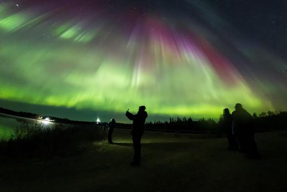 People taking photos of the aurora.