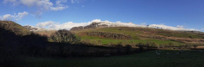 Mountains of Eryri with some snow at higher levels. A crisp winter sun lights the scene.