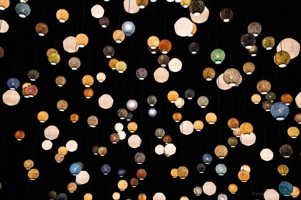 Spherical lights in many colours, an art project. The context, it was in a church, is missing. 