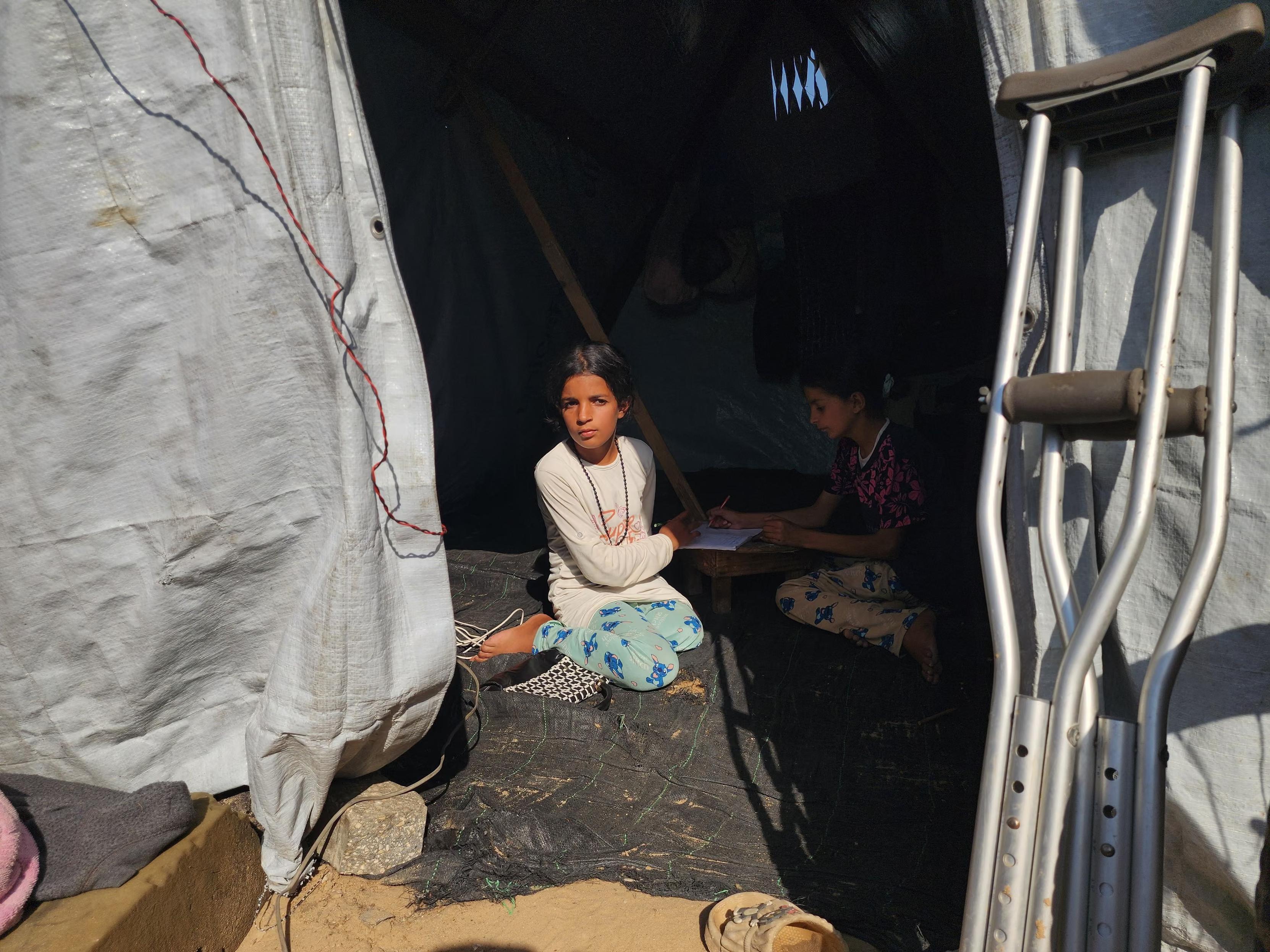 Asil al-Najjar, 11, and her 10-year-old sister, Cena, are living in in a tent months after being severely injured in an Israeli attack. Asil lost a leg due, while Cena suffered a serious knee injury.