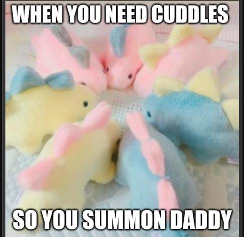 Blue, pink and yellow plush dinosaurs in a circle. Text above and below reads "when you need cuddles so you summon Daddy."