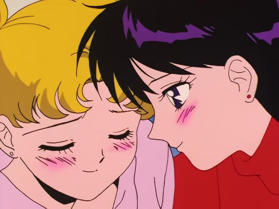 Close-up frames of Usagi Tsukino and Rei Hino leaning close with warm, blushing expressions. The two girls sit side by side, smiling shyly. Their foreheads nearly touch in one shot, with Usagi closing her eyes in the second.