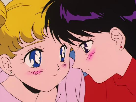 Close-up frames of Usagi Tsukino and Rei Hino leaning close with warm, blushing expressions. The two girls sit side by side, smiling shyly. Their foreheads nearly touch in one shot, with Usagi closing her eyes in the second.