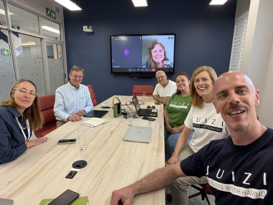 Team NITheCS and team Juizi sitting in the boardroom of the new NITheCS offices at Stellenbosch University.