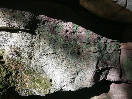 A photograph of a shadowed rock face
