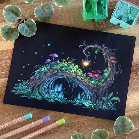 A photo of a landscape-format painting on black paper, placed on a wooden table and surrounded by jelly gouache tubs, coloured pencils, and leaves for decoration. The painting features a horizontally arching tree with a little spiral on top, to which a tiny lantern is attached, emitting a warm orange glow. The tree is overgrown with moss and different kinds of mushrooms, some of them bioluminescent, emitting a soft cold blue glow.