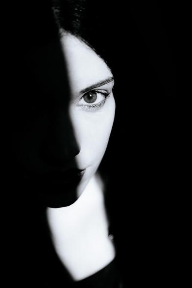 Cara de mujer morena en sombra.