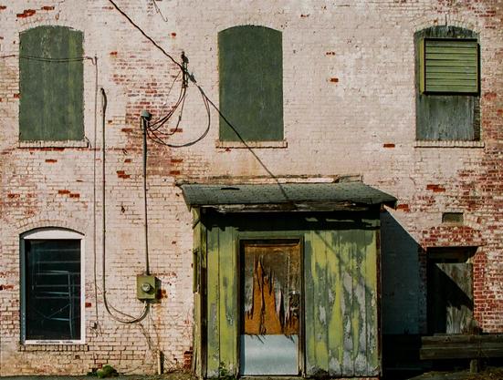 The back of an urban building in a small town.