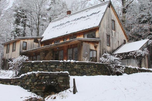 content is marketing: photograph of Adrian's Vermont home in winter, showing his active solar collectors (built into the roof) covered with snow