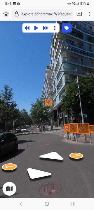 A screenshot captures the 'street view' alternative offered by Panoramax in a western suburb of Paris, as-viewed through a mobile web browser. It shows the usual navigation and directional markers for forward, reverse, and turning to the left/right at street corners at center-screen, as well as 'play' controls to follow the route a pic at a time.

There are also highlighted orange rectangles showing every recognizable street and road sign within the 360-degree rotatable camera captured images. The highlighter can be disabled or enabled by the user by tapping the 'tag' icon next to the player controls.
