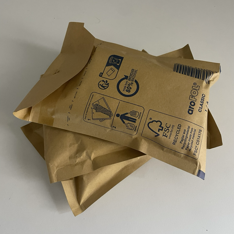 Pequeños sobres color marrón con cassettes preparados para enviar