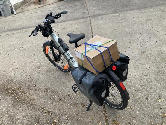A bike with a large(ish) box on the rack.