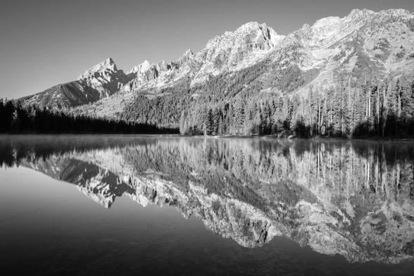 The Tetons, reflected in the misty waters of String Lake. From left to right, Teewinot Mountain, Grand Teton, Symmetry Spire, Mount Saint John, and Rockchuck Peak.