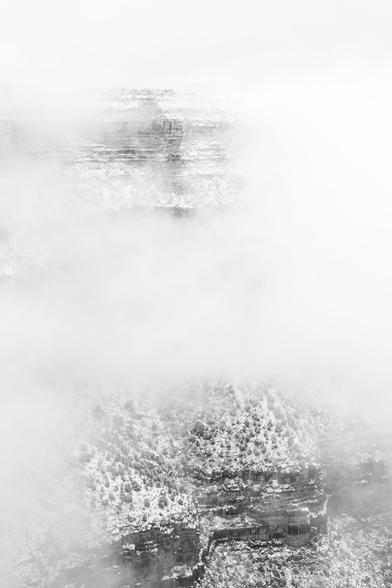 The South Rim near Maricopa Point peeking out of the fog during a snowstorm.