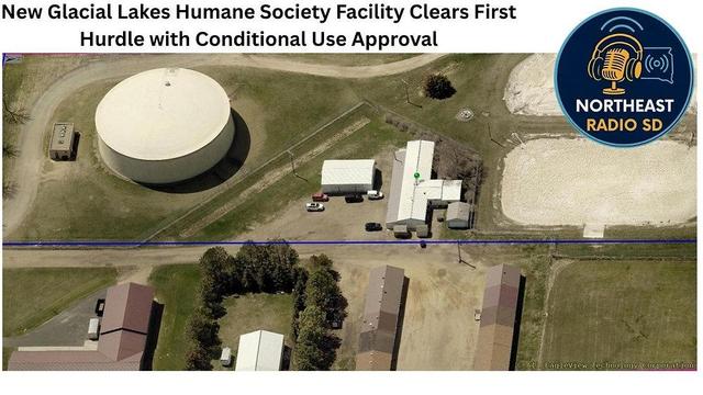 Aerial view of Glacial Lakes Humane Society with buildings, large circular structure, and text: "Facility Clears First Hurdle." Logo in corner.