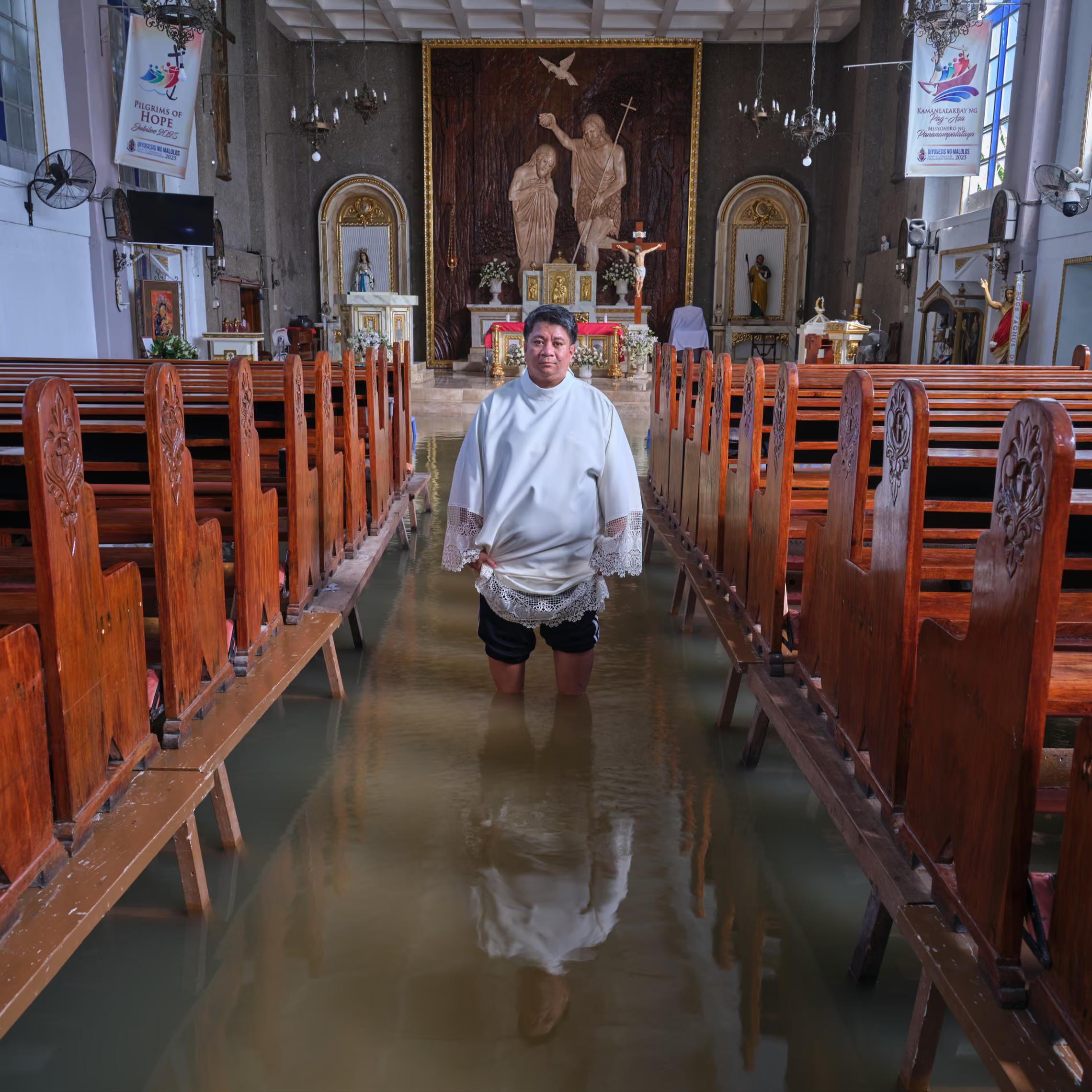 A priest inside his flooded church.
"This current flood is because of the Typhoon Yuan, combined with the high tide. I definitely see this as connected with climate change. The people have not experienced this kind of flood being so frequent."