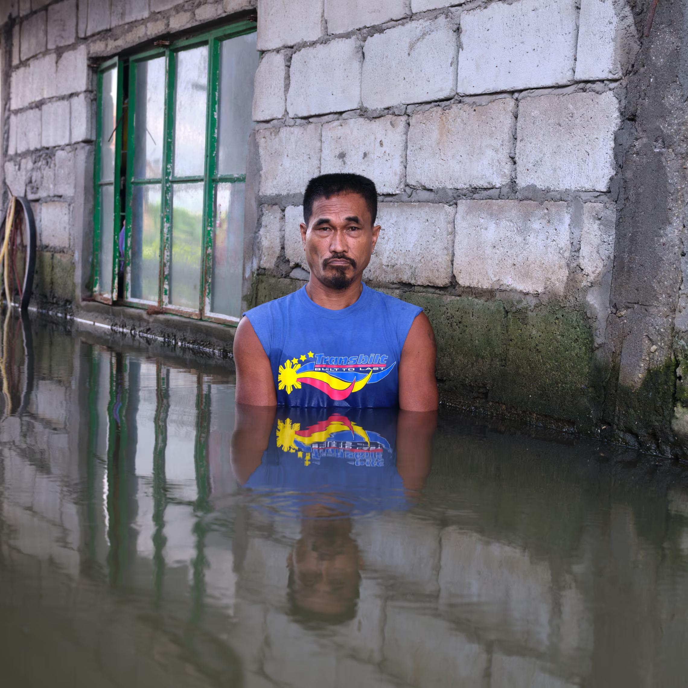 A man stands in his flooded house.
"This will take until December. Garbage disposal should be done in a proper manner as it’s blocking the water channels. Cutting down trees also affects the ground."