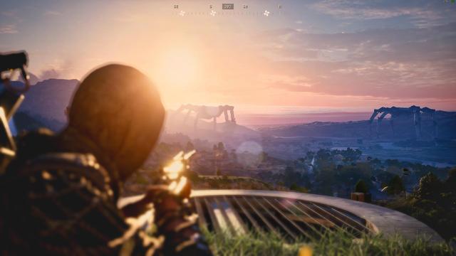 Thrid-person game screenshot from ARC Raiders: A hooded figure aims a weapon over a grassy ledge toward a sunset-lit landscape, with a massive, distant robotic walker (the Arc) silhouetted against pink clouds, mountains, and a misty valley below. HUD elements show compass near top.