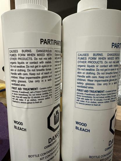 Bottles of Part A and Part B of the 2-art bleach. Part A contains Hydrogen Peroxide, and Part B contains Sodium Hydroxide. 