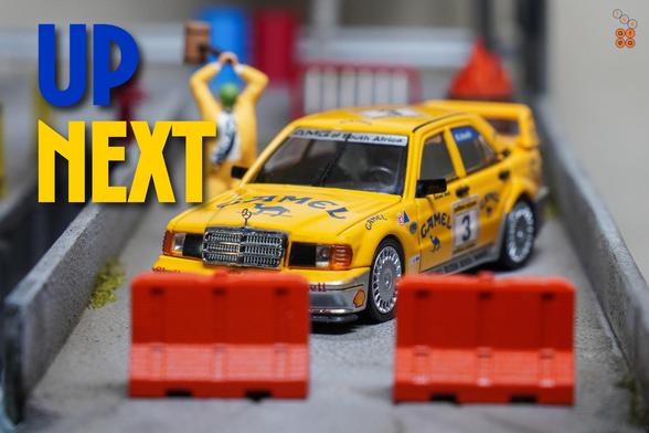A Mercedes Benz 190E, Camel 1990 Yellow Page livery by LMLF in 1:64 scale with 1:64 figure on AREA 164.
